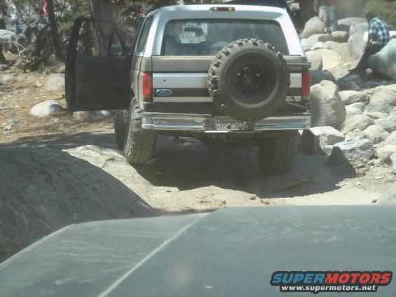 1994 Ford Bronco rear view with spare tire on back and open driver door