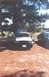 2002 Ford Crown Victoria - A white and black 2002 Ford Crown Victoria is parked with its hood and driver door open, next to another dark-colored vehicle.