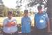 2002 Ford Crown Victoria - Three men are standing outside in front of trees and a field. The man on the right wears a watch.