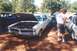 2002 Ford Crown Victoria - A 1965 Pontiac GTO is displayed with its hood open at an outdoor car show.
