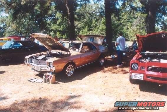 Orange 1970 AMC Javelin with hood open, parked outdoors