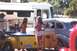 2002 Ford Crown Victoria - A vintage car and trailer are parked near an RV, with two women standing nearby.