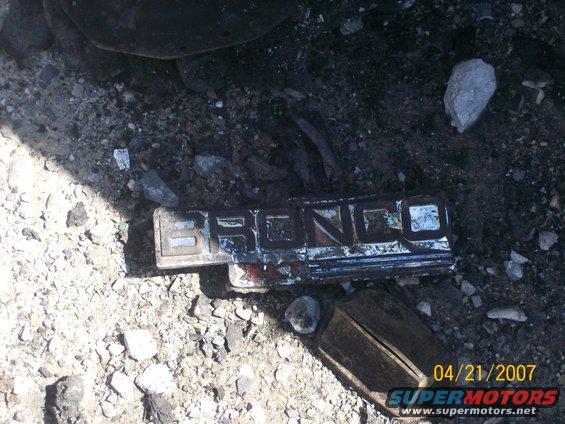 Bronco emblem lying on rocky ground