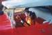 2002 Ford Crown Victoria - Two dolls are seated in the interior of a red vintage car, appearing to be passengers.
