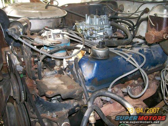 1978 Ford F-250 engine bay with blue valve covers and a carburetor