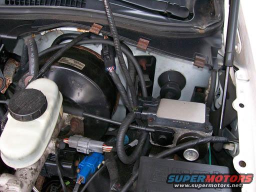 Engine bay showing brake booster, master cylinder, and wiring