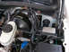 1999 Ford Crown Victoria - Close-up view of the engine bay, focusing on the brake booster and master cylinder assembly.