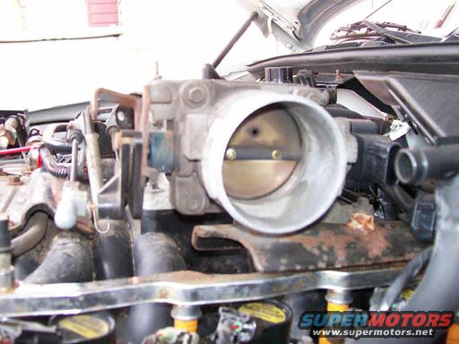 Close-up of a car's throttle body and intake manifold, showing engine parts