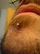 1989 Ford Bronco - A close-up view captures a silver stud piercing in a person's eyebrow.
