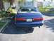 1995 Ford Thunderbird - Rear view of a blue sedan with a Florida license plate, parked outdoors.