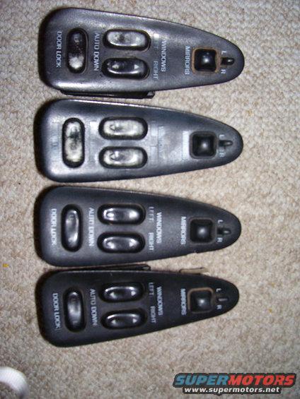 Four car door window and mirror control switch assemblies stacked on a carpeted surface