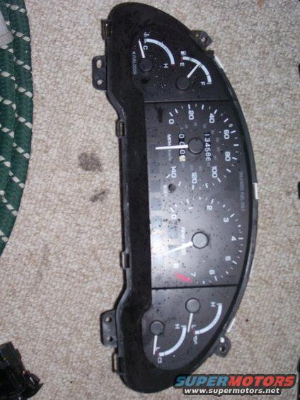 Car dashboard instrument cluster with speedometer, tachometer, fuel, and temperature gauges