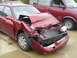 1996 Ford F-350 - This red sedan sustained significant damage to its front end, including a caved-in hood and shattered windshield.