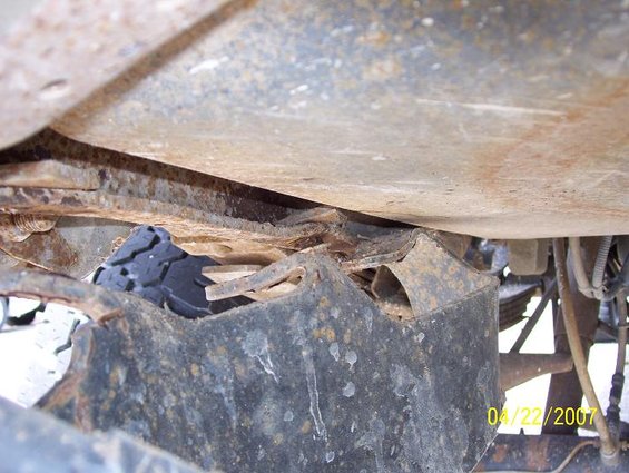 Undercarriage detail with visible rust and a tire fragment; dated 04/22/2007