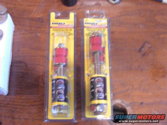 Two red and silver suspension bushings in yellow packaging