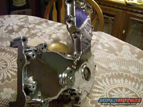 Chrome engine part with mounting holes and circular openings