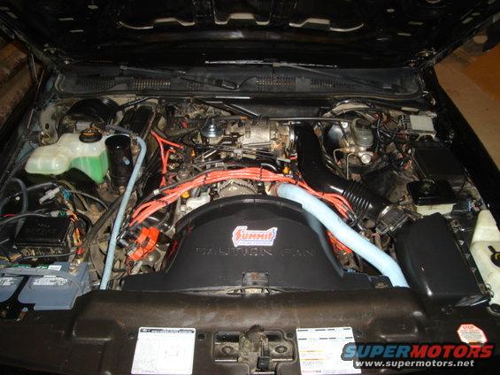 1992 Ford Crown Victoria engine bay with Summit racing fan, orange spark plug wires, and two batteries