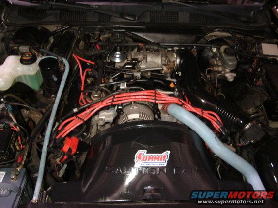 1992 Ford Crown Victoria engine bay with red spark plug wires and a black Summit Racing air intake cover