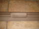 1996 Ford Bronco - Close-up of a tan interior trim piece with the word "BRONCO" embossed into the handle area.