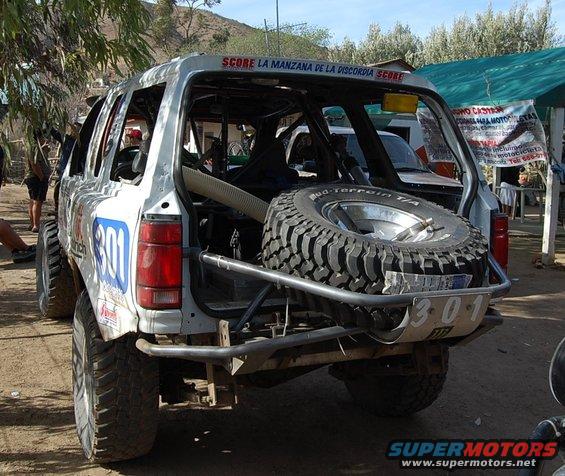 Off-road race truck rear view with spare tire and number 301