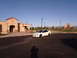 1996 Ford Probe - A white Dodge Neon SRT-4 is parked in front of a tan building under a clear blue sky.