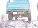 1996 Ford Bronco - The rear of a green Ford Bronco is shown, lifted with off-road tires, on a rocky terrain.