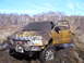 1996 Ford Bronco - This GMC pickup truck is heavily covered in mud after getting stuck in a wet, wooded area.