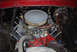 1979 Ford F-150 - The engine bay of a 1979 Ford F-150 shows its V8 engine, complete with an air cleaner and various hoses and wires.