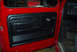 1979 Ford F-150 - Interior view of a red 1979 Ford F-150, showing the driver's side door panel and dashboard.