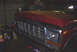 1979 Ford F-150 - Front end of a red 1979 Ford F-150 pickup truck, showing the grille and headlights.