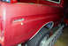 1979 Ford F-150 - Rear quarter panel of a red 1979 Ford F-150 pickup truck, showing a missing tail light assembly.