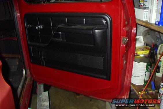 Red truck door interior panel with black trim and handle