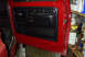 1979 Ford F-150 - Interior view of a red truck door panel, consistent with a 1979 Ford F-150.