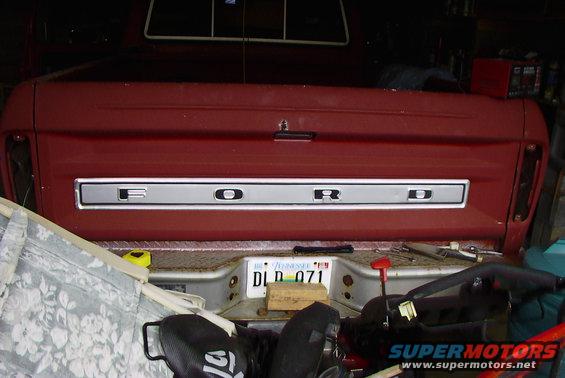 Red 1979 Ford F-150 tailgate with chrome FORD lettering and a license plate