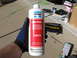 1973 Ford Ranchero - A bottle of Mar-Hyde One-Step rust converter is held in a gloved hand, with various tools and supplies in the background.