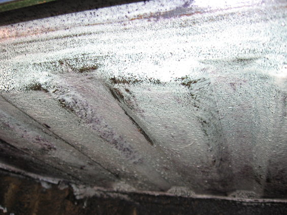 Underside of a vehicle with ribbed metal panels coated in white material