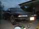 1989 Mazda MX-6 - A black 1989 Mazda MX-6 is parked in a driveway under an overhang, with a license plate visible.