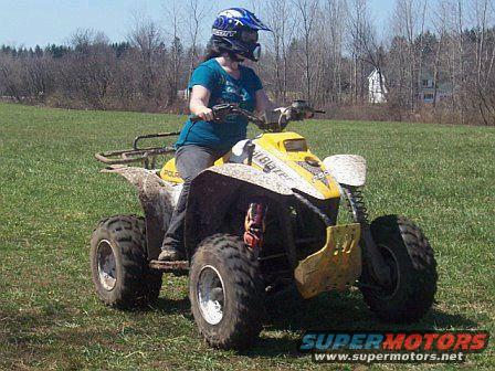 Rider on a yellow 2001 Polaris TRAIL BLAZER ATV in a grassy field