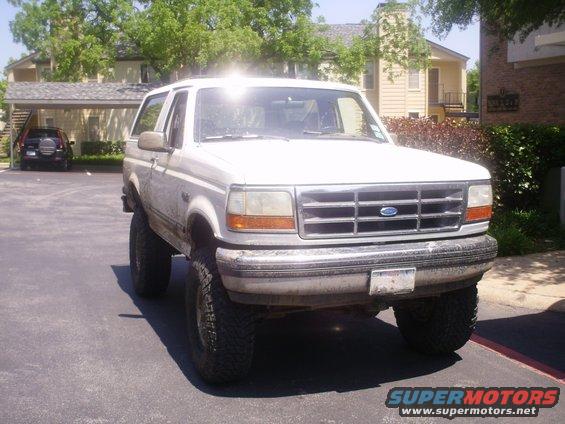 White 1992 Ford Bronco with lifted suspension parked outdoors