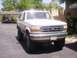 1992 Ford Bronco - This lifted 1992 Ford Bronco is parked in a residential area, showing off its off-road capabilities.