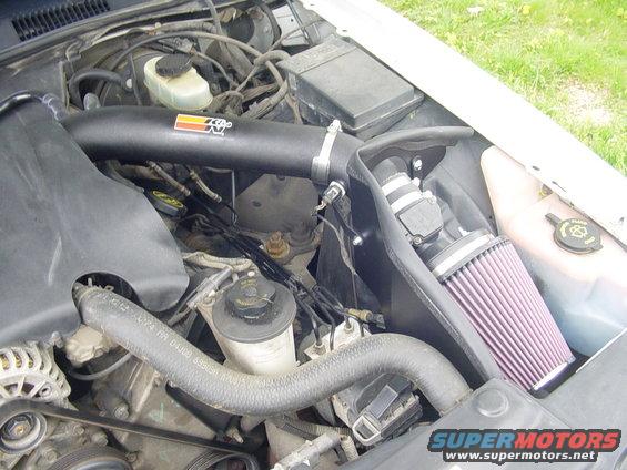 Engine bay showing a K&N air intake system installed. Some hoses and engine components are visible