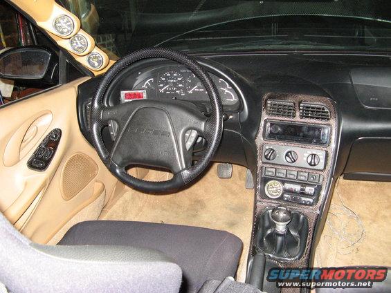 Car interior with dashboard, steering wheel, and gear shift