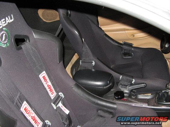 Interior view of racing seats with Simpson harnesses and a center console