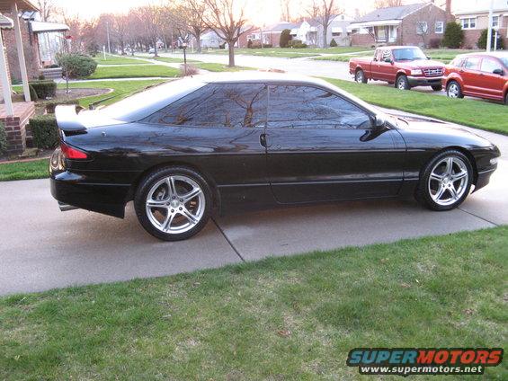 black 1995 Ford Probe parked on driveway, side view