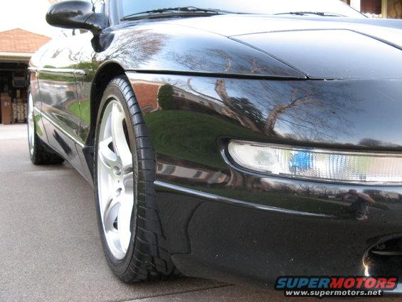 Black 1995 Ford Probe front corner with alloy wheel and headlight visible