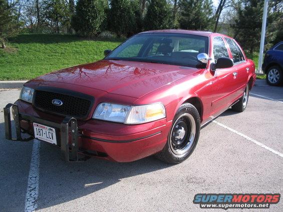 Red 2001 Ford Crown Victoria with push bar and black grille