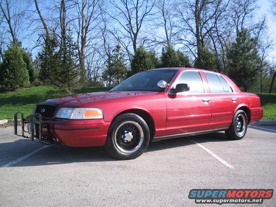 2001 Ford Crown Victoria with push bumper parked on asphalt