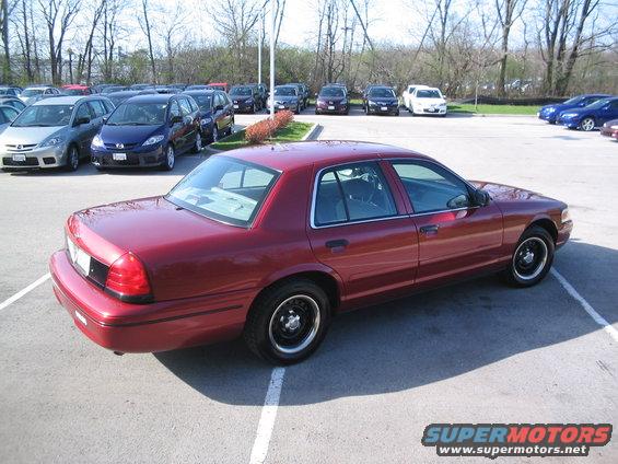 Red 2001 Ford Crown Victoria 3q-front view