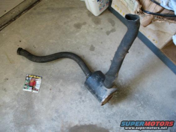 Exhaust pipe and muffler on concrete floor with magazine