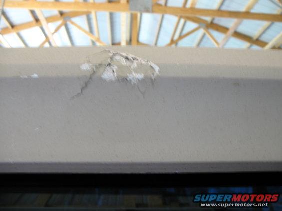 damaged ceiling with exposed wood beams and metal structure above